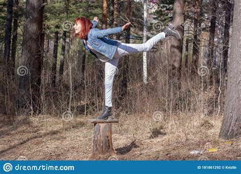 A Smiling Red Haired Teenager Girl Does An Acrobatic Stunt Called