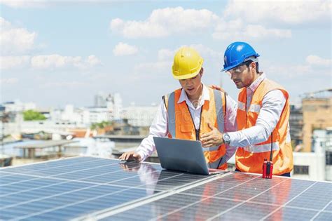 Solar Panel Technician On Roof Engineer And Young Technician In Solar