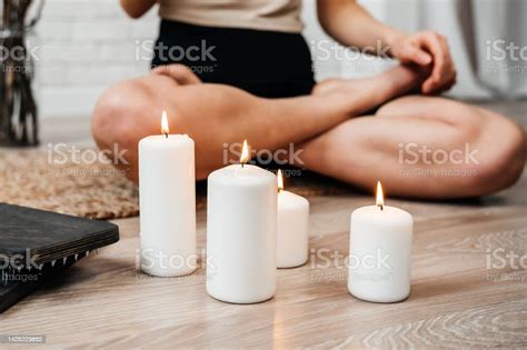 The Girl Meditates With Lit White Candles Sadhu Board Concept On