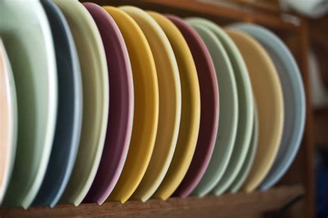 Assortment Of Colored Clean Dinner Plates In Rack Free Stock Image