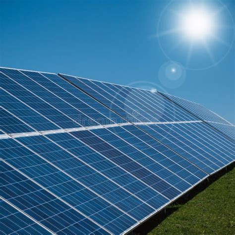 Solar Power Plant Panels With Sun Rays And Blue Sky Stock Photo Image