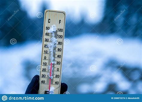 Winter Time Thermometer On Snow Shows Low Temperatures In Celsius