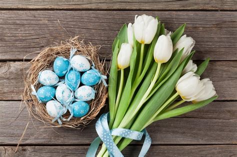 Premium Photo Easter Eggs In Nest And White Tulips