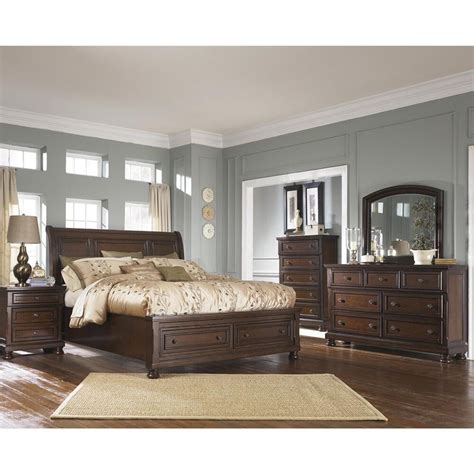 Beveled framing reflects beauty in the details. Millennium Porter 5 Piece King Storage Bedroom Set in ...