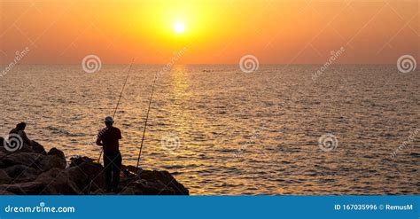 Fisherman On The Ocean Shore At Sunset Editorial Photo Image Of