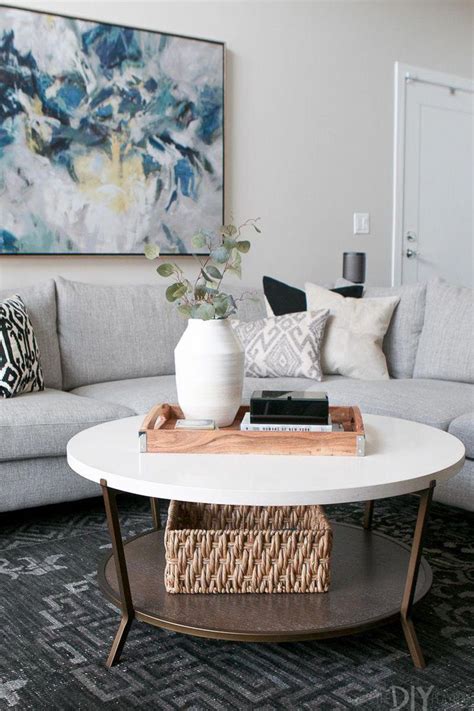 Natural medium round wood coffee table. A round coffee table next to a large gray sectional. Love ...