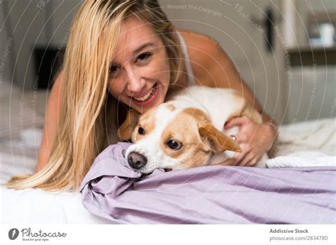 Sexy Young Woman At Home Playing With Her Dog A Royalty Free Stock