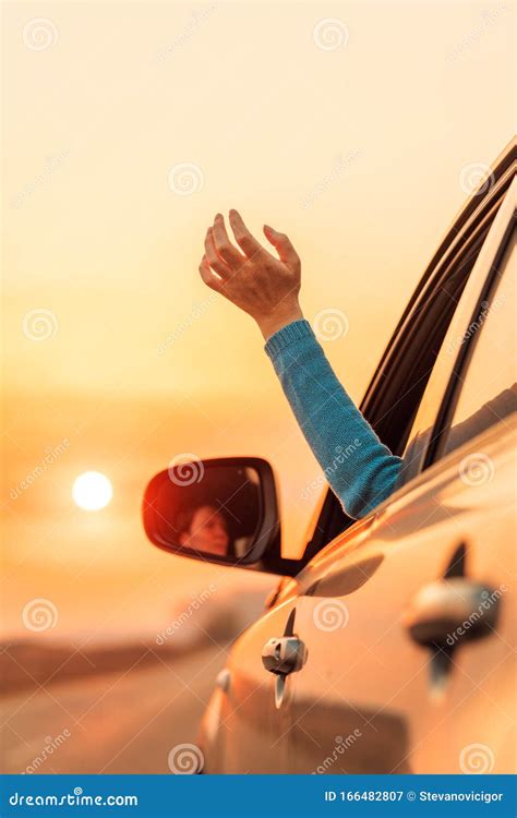 Woman Driver Putting Hand Out Of Car Window While Driving Stock Image