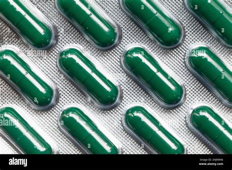 Pack of green capsule pills, close-up photo, top view Stock Photo - Alamy