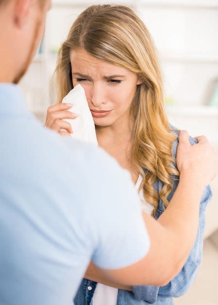 Premium Photo Young Woman Crying While Husband Soothing Her