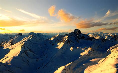 Sunset Over Snow Capped Mountains