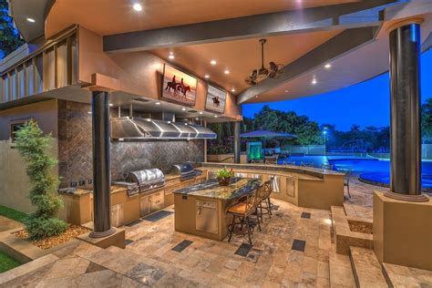 See more ideas about outdoor kitchen, modern outdoor kitchen, outdoor kitchen design. Contemporary Porch with Outdoor kitchen, Raised beds, Wrap around porch, exterior tile floors ...