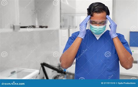 Stressed Doctor Or Male Nurse Having Headache Stock Photo Image Of