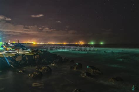 Tropical Beach At Night With City Lights In Background Hdr Stock