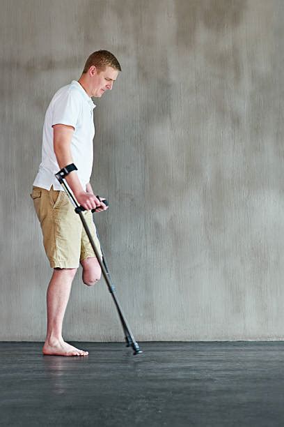 Royalty Free Handicapped One Legged Man Walking On Crutches Pictures