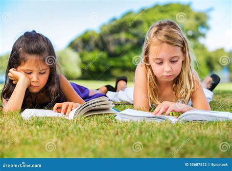 Little Girls Reading Books On Grass Stock Photo Image Of Hobby Lawn