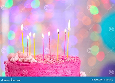 Delicious Birthday Cake And Burning Candles Against Blurred Lights
