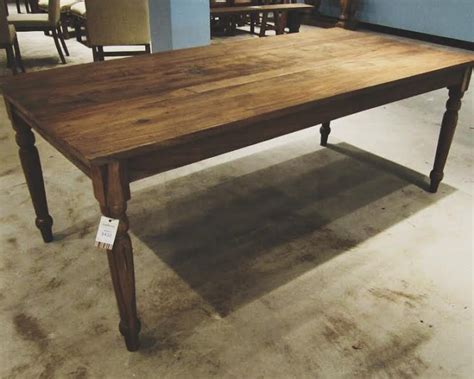 The plank dining table is made of solid pinewood and is supported by a thick apron. Farm Dining Table - Nadeau Birmingham