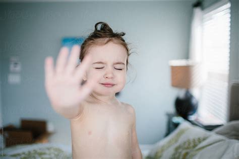 A Cute Babe Standing On A Bed Showing The Palm Of Her Hand By Stocksy Contributor Jakob