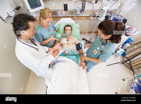 Doctor And Nurses Treating Critical Patient In Hospital Stock Photo Alamy