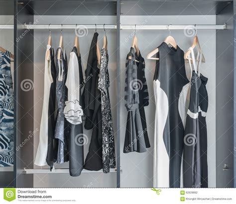 Black And White Clothes Hanging In Closet Stock Photo