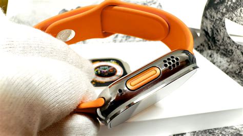 Polished Apple Watch Ultra With Orange Button And Hermes Sport Band