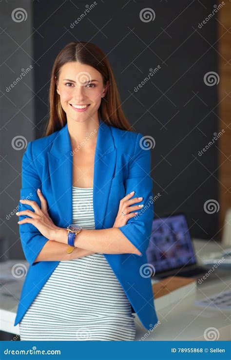 Portrait Of A Beautiful Business Woman Standing Near Her Workplace