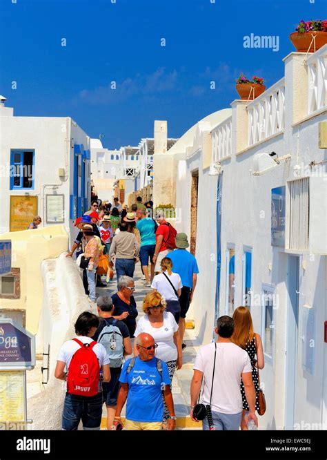 Tourists Walking Through The Busy Streets Of Oia Santorinigreece