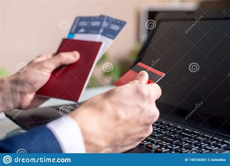 If you are in rush to get an airline ticket and reach your destination, debit card may not be as good an option as credit card. Man Holding Airline Ticket And Debit Card In Hand Buying On The Internet Using A Laptop ...