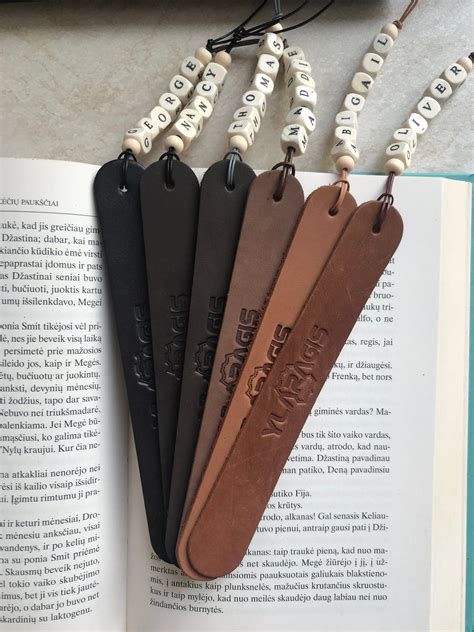 Four Bookmarks Are Hanging From An Open Book