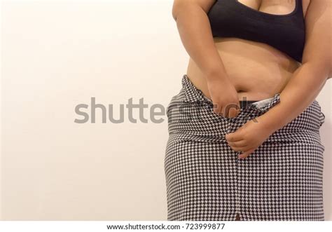 Overweight Woman Trying Fasten Her Skirt Stock Photo
