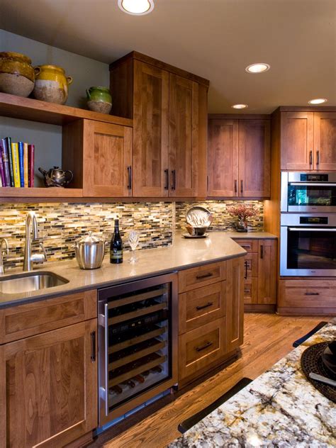 Pick a soft blue hue that complements the color of your cabinets and hardware to achieve a cohesive look. Traditional Wood Kitchen Cabinets and Mosaic Tile Backsplash | HGTV