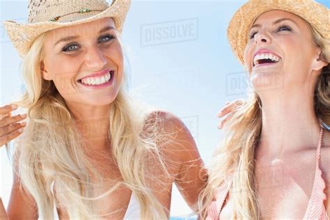 Women Laughing Together On Beach Stock Photo Dissolve