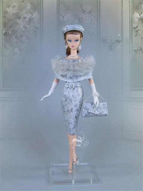 A Barbie Doll Dressed In An Elegant Dress And Hat With Fur Stoler