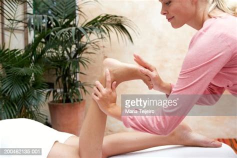 Young Woman Lying On Treatment Table Receiving Foot Massage High Res