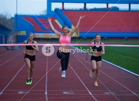 Female Runners Finishing Athletic Race Together Royalty Free Stock