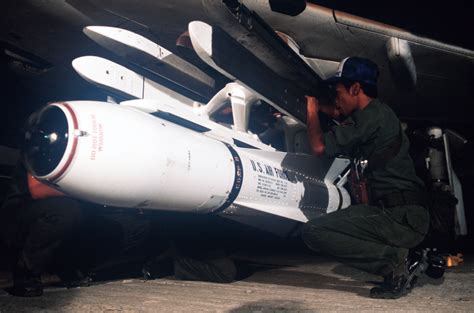 Munitions Personnel Load An Agm 65a Maverick Missile On The Wing Of A