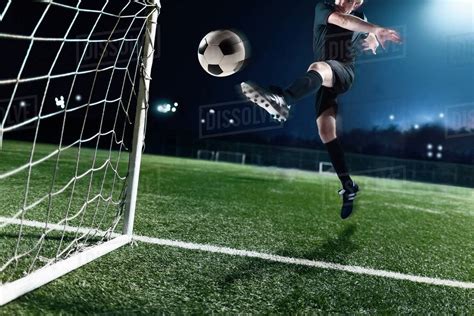 Athlete Kicking Soccer Ball Into A Goal Stock Photo Dissolve