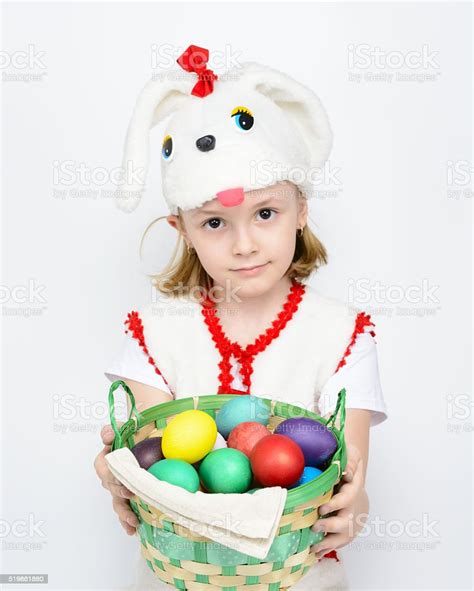 Girl In Rabbit Costume With A Basket Of Easter Eggs Stock Photo