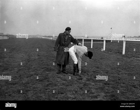 devon loch s disconsolate jockey dick francis is given a consoling pat on the course after his