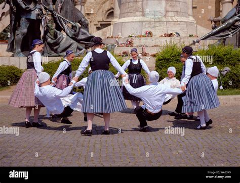 Hungarian Traditional Dance Troop In Folkloric Customs With A Public