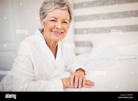 Portrait Of Senior Woman Sitting On Bed Stock Photo Alamy