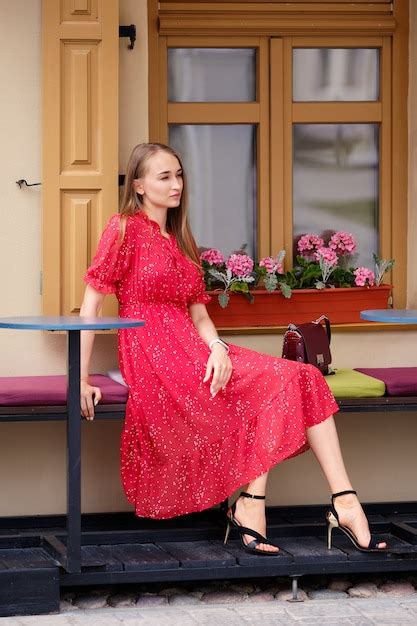 Premium Photo Cute Girl In Red Dress Resting On Cafe Terrace