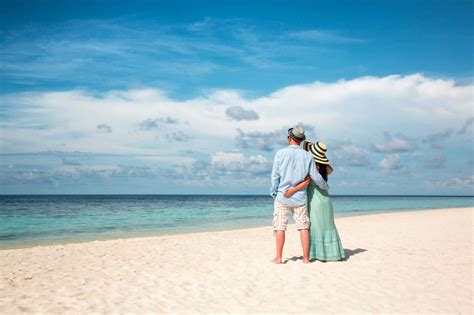 Download Couple At Beach Standing Under Blue Sky Picture