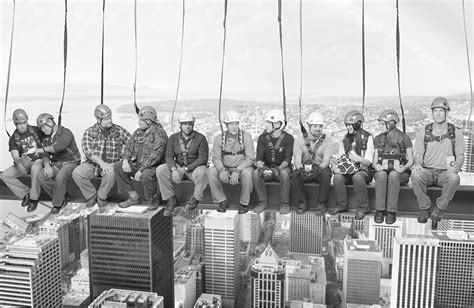 Construction Workers Eating Lunch On Beam