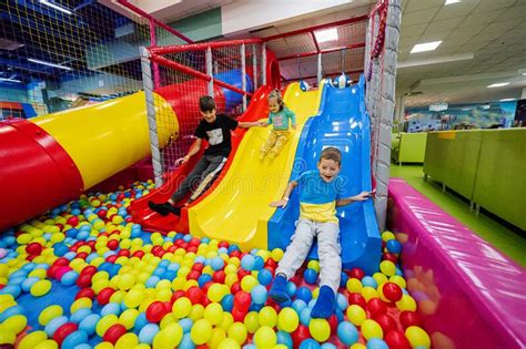 Happy Kids Playing At Indoor Play Center Playground Children Slides In