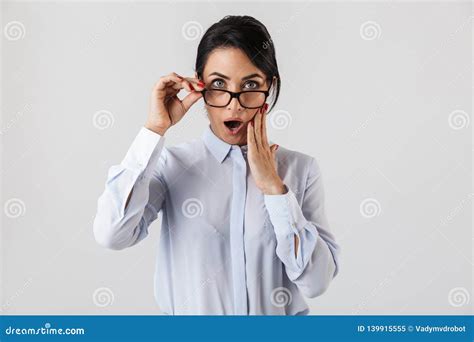 portrait of excited secretary woman 30s wearing eyeglasses standing in the office isolated over