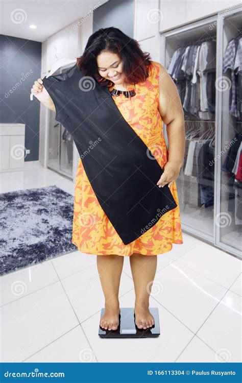 Fat Woman Measuring Her Body In A Clothing Room Stock Photo Image Of
