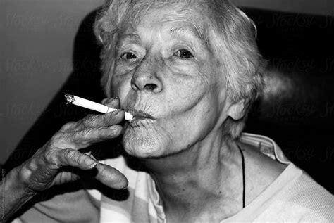 Elderly Woman Smoking A Cigarette By Stocksy Contributor Chelsea