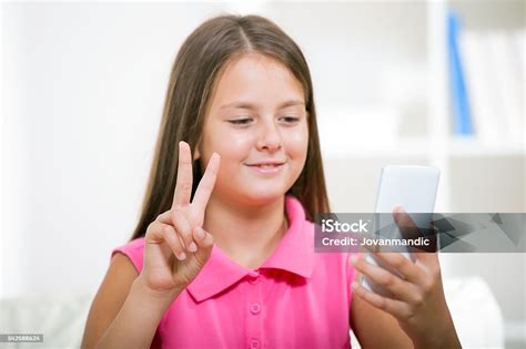Smiling Deaf Girl Talking Using Sign Language On The Smartphone Stock